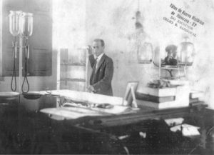 Foto dos anos 20, do médico Dr. José Aníbal Soares de Oliveira, no Ambulatório do Hospital São Francisco de Assis, onde hoje funciona a empresa ConstruNeves. Ele, que dá nome a principal avenida de Ituverava, devido ao seu espírito humanitário e altruísta, era considerado “Apóstolo do Bem e da Caridade”. O dr. Soares, que faleceu em 26 de abril de 1958, era casado com Ana Felismina Robin Rodrigues (“Dona Anita”), e formaram uma família sólida e bem constituída. Entre seus filhos, está o também médico Dr. Nelson Soares de Oliveira, que, tal como o pai, era um cidadão humanitário e desprendido. Dr. Nelson foi fundador do Hospital São Jorge, atualmente Hospital e Maternidade – São Jorge.